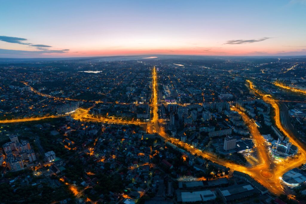 Aerial view of a bustling global metropolis at dusk, showcasing the network and range of SugarMommy MX